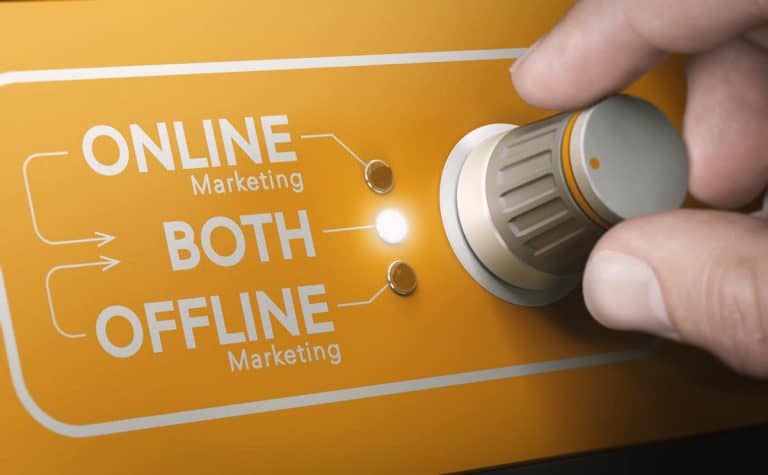 Hand adjusting a marketing switch between online and offline strategies.