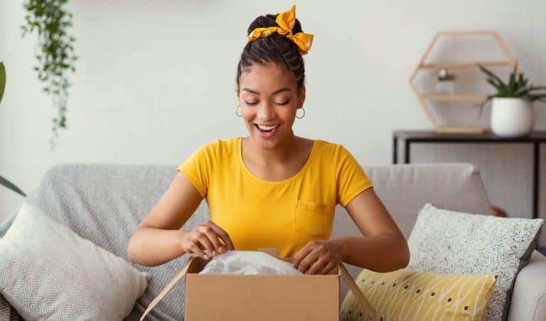 woman opening package and smiling