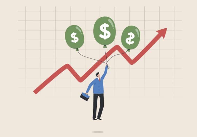 man with balloons with dollar signs on them in front of a graph trending upwards representing inflation
