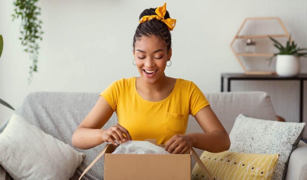 woman opening package and smiling